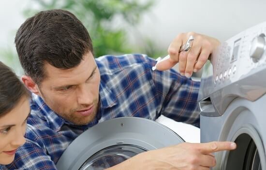 Technician showing a homeowner the inside of a front-load washer